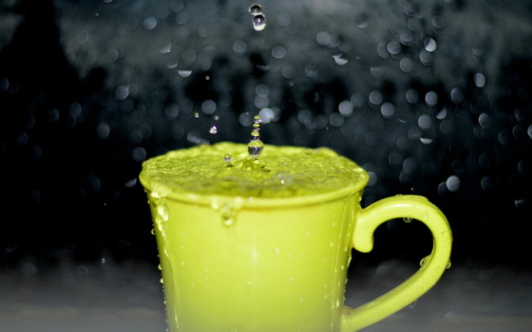 yellow ceramic mug with water droplets in time lapse photography